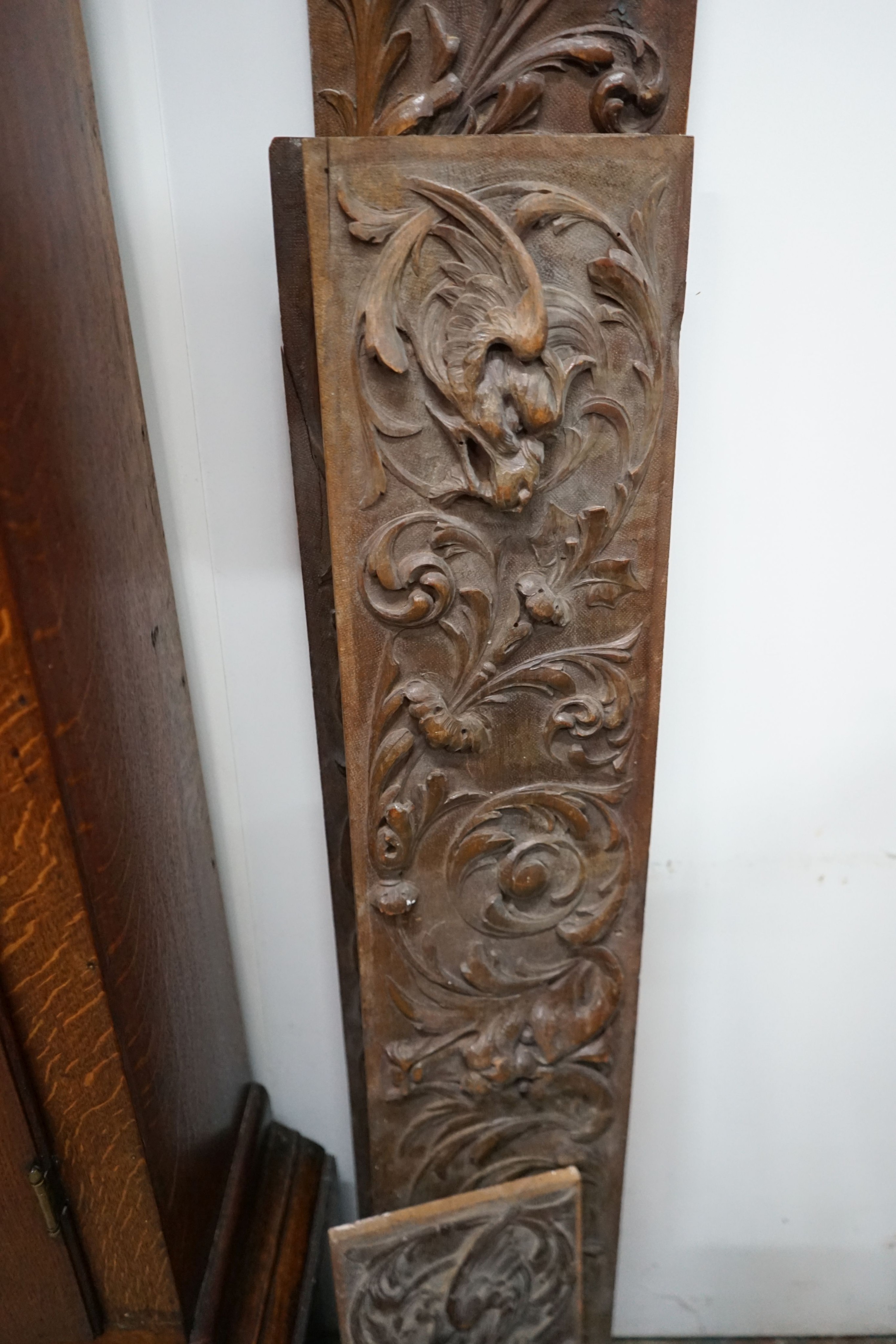 Four rectangular carved oak panels, largest length 152cm